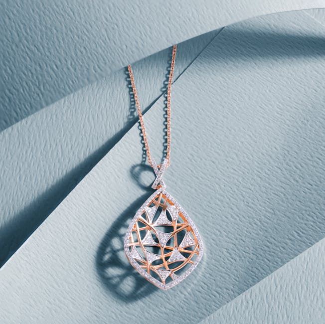 Luxurious diamond pendant with intricate design on a soft blue textured surface, showcasing elegance and craftsmanship.